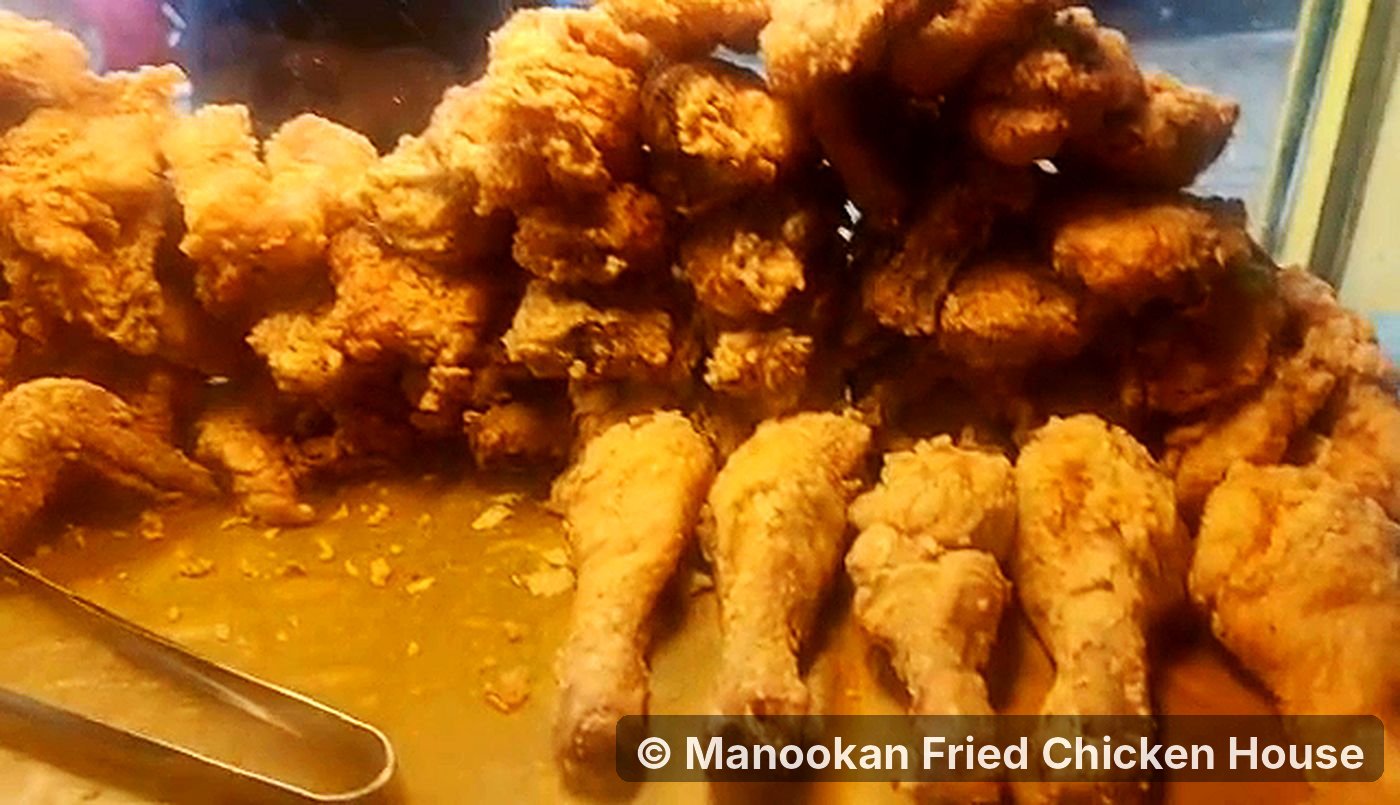 A pile of golden fried chicken in the Manookan display case